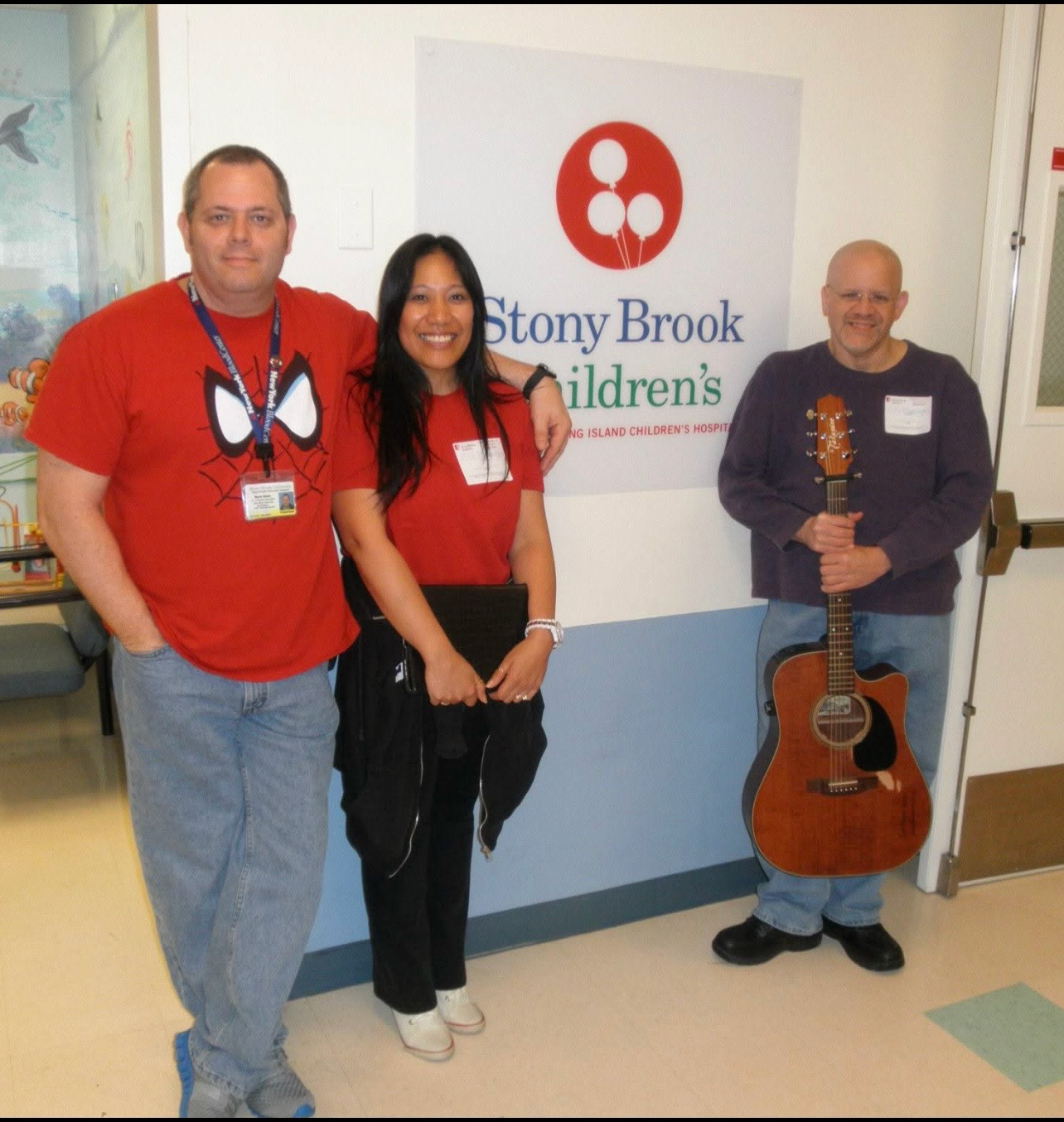 Three people posing at Stony Brook Children's Hospital