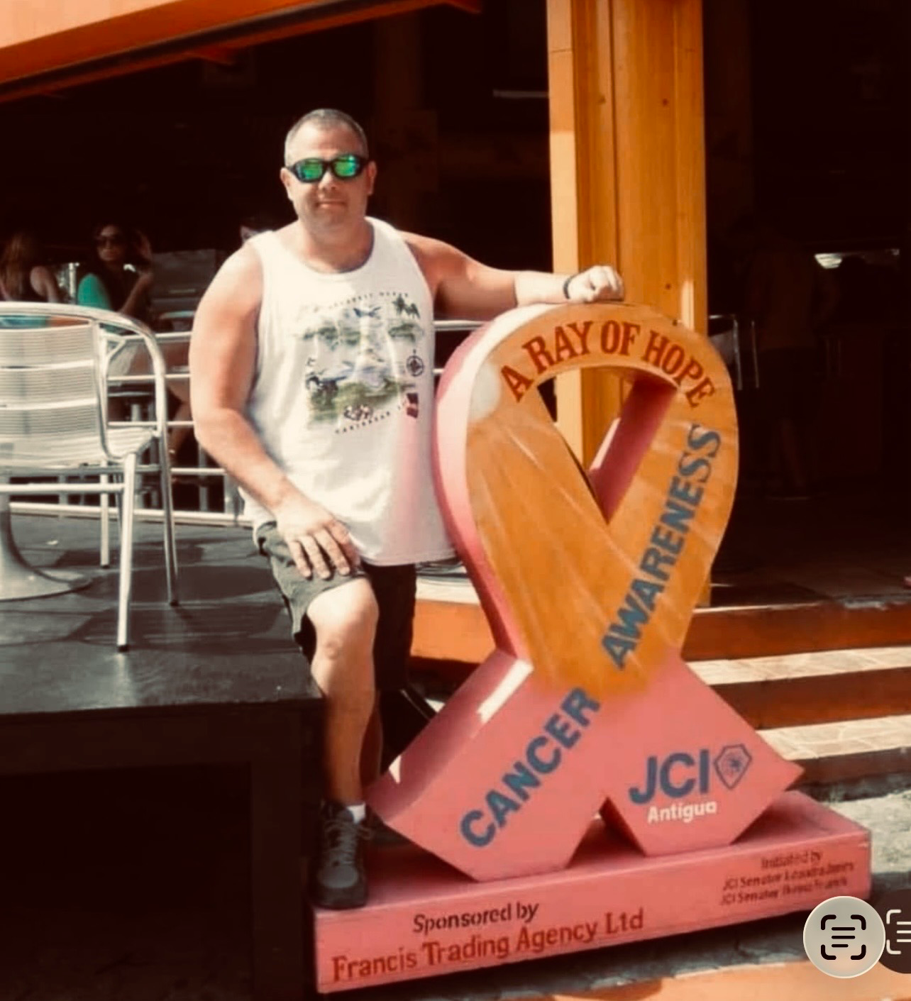 Man with cancer awareness ribbon sculpture